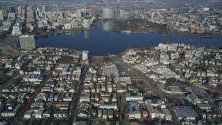 DCSF05_001 - 5K stock footage aerial video Tilt from an urban neighborhood, reveal and approach Lake Merritt, Downtown Oakland, California