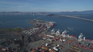 DCSF05_004 - 5K aerial stock footage Tilt from shipping containers at the Port of Oakland, reveal Bay Bridge, San Francisco Bay, California