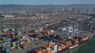 DCSF05_078 - 5K aerial stock footage Flying by cargo cranes, shipping containers, cargo ships, Port of Oakland, Oakland, California