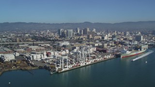 DCSF05_080 - 5K aerial stock footage Flying by Port of Oakland Inner Harbor, Downtown Oakland in the background, California