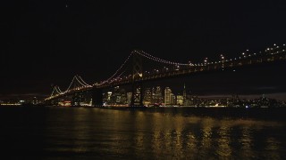 DCSF06_002 - 5K aerial stock footage Approach and fly over Bay Bridge, approach Downtown San Francisco skyline, California, night