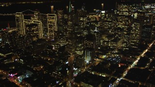 DCSF06_065 - 5K aerial stock footage Tilt up Columbus Avenue to reveal Transamerica Pyramid and skyscrapers, Downtown San Francisco, California, night