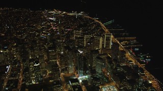 DCSF06_077 - 5K aerial stock footage Tilt up from The Embarcadero to reveal I-80 and Downtown San Francisco, California, night