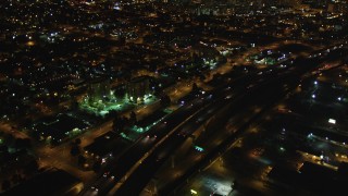 DCSF06_091 - 5K stock footage aerial video Tilt from light traffic on Interstate 880, revealing Downtown Oakland, California, night