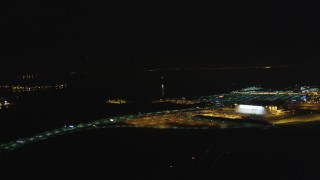 DCSF06_102 - 5K aerial stock footage Track a small plane landing at Oakland International Airport, Oakland, California, night