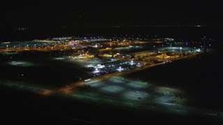 DCSF06_105 - 5K aerial stock footage Reverse view of Oakland International Airport, Oakland, California, night