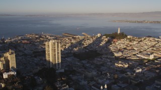 DCSF07_006 - 5K aerial stock footage of A view of Coit Tower while flying by Russian Hill high-rises, San Francisco, California, sunset