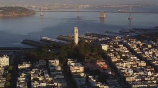 DCSF07_008 - 5K aerial stock footage Approach Coit Tower with Bay Bridge in background, North Beach, San Francisco, California, sunset