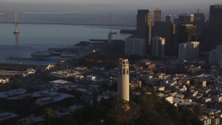 DCSF07_009 - 5K aerial stock footage Flying by Coit Tower and the Financial District skyline, Downtown San Francisco, California, sunset