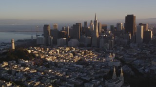 DCSF07_031 - 5K aerial stock footage Flying away from Coit Tower and the downtown skyline, Downtown San Francisco, California, sunset