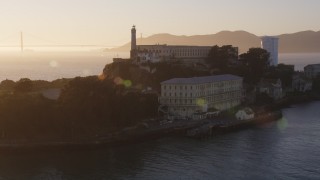 DCSF07_034 - 5K aerial stock footage Orbiting Alcatraz with the setting sun in the background, San Francisco, California, sunset