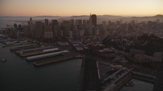 DCSF07_081 - Aerial stock footage of 5K Aerial Video Fly away from piers, Coit Tower, and Downtown San Francisco, California, twilight