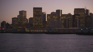 DCSF07_087 - Aerial stock footage of 5K Aerial Video Fly low by piers and approach skyline of Downtown San Francisco, California, twilight