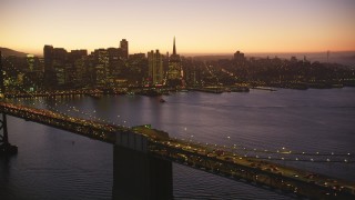 DCSF07_099 - Aerial stock footage of 5K Aerial Video Reverse view of Bay Bridge and Downtown San Francisco skyline, California, twilight