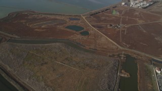 DCSF08_006 - Aerial stock footage of 5K Aerial Video Reverse view of sloughs, reveal homes and Sea Breeze Park, Union City, California