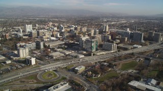 DCSF09_001 - Aerial stock footage of 5K Aerial Video Tilt from Target rooftop to reveal and approach Highway 87 and Downtown San Jose high rises, California