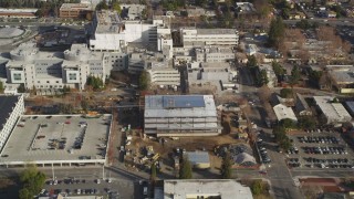 DCSF09_010 - Aerial stock footage of 5K Aerial Video Reverse view of suburban neighborhoods, reveal Santa Clara Valley Medical Center, San Jose, California