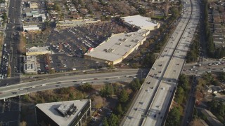 DCSF09_012 - Aerial stock footage of 5K Aerial Video Reverse view of neighborhoods beside Interstate 280, reveal shopping center, San Jose, California