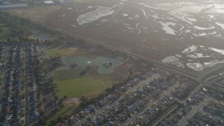 DCSF09_033 - Aerial stock footage of 5K Aerial Video Reverse view of marshland, San Lorenzo Park, neighborhoods in San Lorenzo, California