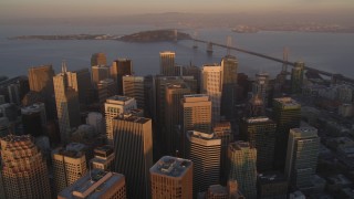 DCSF10_006 - Aerial stock footage of 5K Aerial Video Tilt to reveal and fly over skyscrapers in Downtown San Francisco, California, and approach the Bay Bridge, twilight