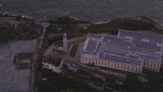 DCSF10_023 - Aerial stock footage of 5K Aerial Video Bird's eye view of the lighthouse and main building, Alcatraz, San Francisco, California, sunset
