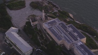 DCSF10_024 - Aerial stock footage of 5K Aerial Video Flying away from Alcatraz lighthouse and main building, San Francisco, California, twilight