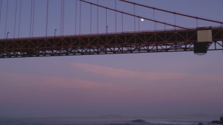 DCSF10_033 - Aerial stock footage of 5K Aerial Video Fly low and look up at the moon and Golden Gate Bridge, San Francisco, California, twilight