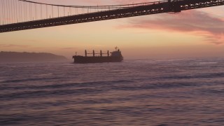 DCSF10_043 - Aerial stock footage of 5K Aerial Video Track oil Tanker approaching Golden Gate Bridge, San Francisco, California, twilight