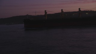 DCSF10_045 - Aerial stock footage of 5K Aerial Video Flyby an oil tanker, reveal Golden Gate Bridge, San Francisco, California, twilight