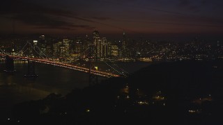 DCSF10_086 - Aerial stock footage of 5K Aerial Video of Downtown San Francisco skyline behind the Bay Bridge, seen from Yerba Buena Island, California, night