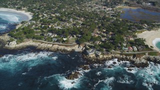 DCSF11_011 - Aerial stock footage of 5K Aerial Video Flyby a coastal neighborhood, waves crashing into rocks, Carmel, California