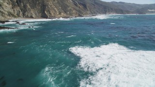 DCSF11_025 - Aerial stock footage of 5K Aerial Video Flying over ocean kelp near coastal cliffs, Big Sur, California