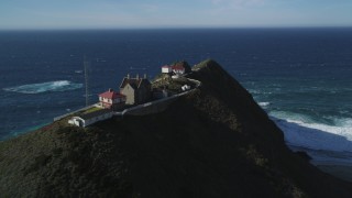 DCSF11_028 - Aerial stock footage of 5K Aerial Video Flying by Point Sur Lighthouse buildings atop a coastal cliff, Big Sur, California