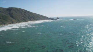 DCSF11_030 - Aerial stock footage of 5K Aerial Video Tilt from ocean kelp to reveal steep cliffs, Big Sur, California
