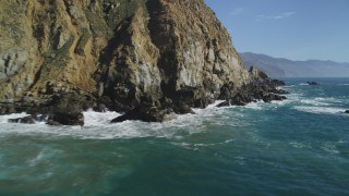 DCSF11_031 - Aerial stock footage of 5K Aerial Video Fly low over waves slamming into coastal cliffs, Big Sur, California
