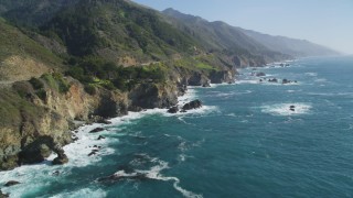DCSF11_037 - Aerial stock footage of 5K Aerial Video Following the coastline, waves crashing into rocks, Big Sur, California