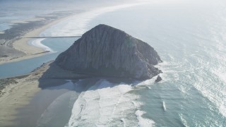 DCSF11_045 - Aerial stock footage of 5K Aerial Video Flying by Morro Rock in Morro Bay, California