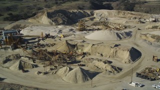 DFKSF01_003 - 5K aerial stock footage of flying by industrial equipment at a quarry, Simi Valley, California