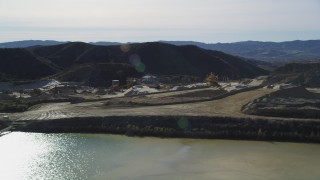 DFKSF01_005 - 5K aerial stock footage orbit a quarry and industrial equipment, Simi Valley, California