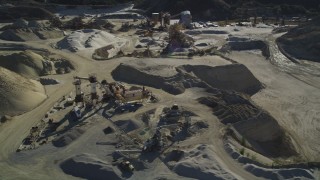 DFKSF01_006 - 5K aerial stock footage of flying by a working quarry, industrial equipment, Simi Valley, California