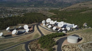 DFKSF01_009 - 5K aerial stock footage of flying by satellite dishes in the hills, Fillmore, California
