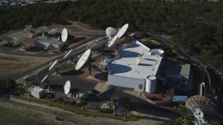DFKSF01_010 - 5K aerial stock footage of orbiting a building with several satellite dishes in the hills, Fillmore, California