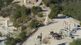 DFKSF01_019 - 5K aerial stock footage of circling oil rigs drilling on a hilltop, Santa Paula, California