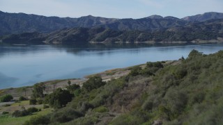 DFKSF01_027 - 5K aerial stock footage of flying over a wooded hillside, revealing Lake Casitas, California