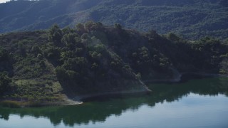 DFKSF01_028 - 5K aerial stock footage of approaching hills on the shore and flying over, Lake Casitas, California