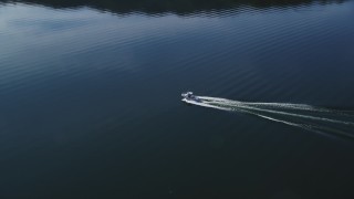 DFKSF01_032 - 5K aerial stock footage of tracking a fishing boat cruising on the lake, Lake Casitas, California