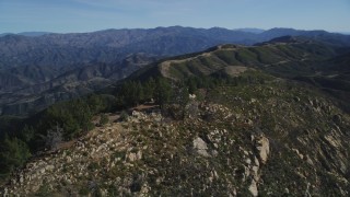 DFKSF01_044 - 5K aerial stock footage approach and orbit tree-lined slopes, reveal radio tower, Santa Ynez Mountains, California