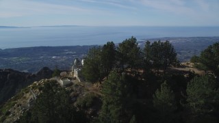DFKSF01_046 - 5K aerial stock footage orbit radio tower on a peak, reveal Santa Barbara, Santa Ynez Mountains, California