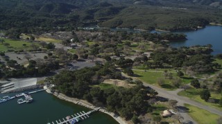 DFKSF01_058 - 5K aerial stock footage of approaching an RV Park with boats at the docks, Lake Cachuma, California