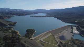 DFKSF01_062 - 5K stock footage aerial video of flying by the Bradbury Dam, tilt to wider view of Lake Cachuma, California